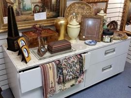Home decor on a four-drawer display unit.