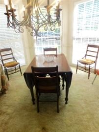 Antique Mahogany drop leaf table with 4 chairs   opens to 84.5 long  by 43 wide