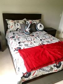 Full size bed with rock band theme linens