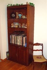 Lighted Bookcase containing Hummels, 78 records, Roseville vase and etc.
