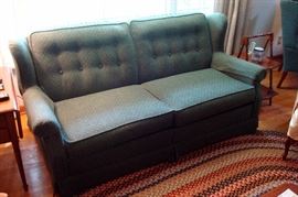 Sleeper sofa and partly shown braided rug.