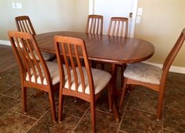 Teak Dining Table with 6 Chairs expands to 8' Long when the 2 leaves stored underneath are easily removed using the gear system.