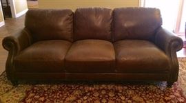 brown leather 3-cushion sofa with nailhead trim