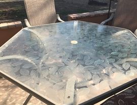 Patterned patio table top is thick plexiglass