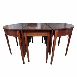 Antique Hepplewhite Three-Part Banquet Table: An early 19th-century Hepplewhite mahogany three-part banquet table. The table includes three sections, with the center section having two hinged leaves, which can be folded down. The three sections can fit together with the center leaves up or down. The skirt and the straight, square tapered legs are embellished with contrasting inlay banding. The table appears to retain the original waxed patina, and the hardware for the table is included. No maker’s marks.