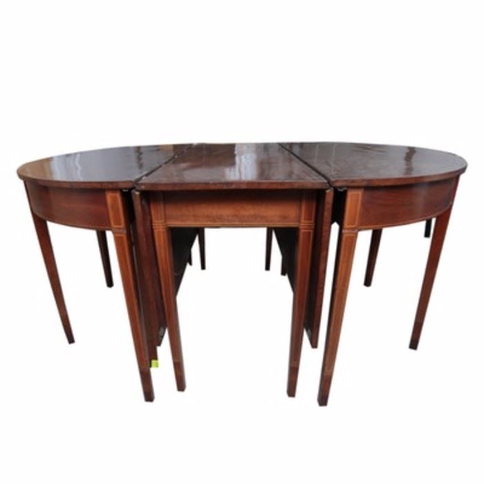 Antique Hepplewhite Three-Part Banquet Table: An early 19th-century Hepplewhite mahogany three-part banquet table. The table includes three sections, with the center section having two hinged leaves, which can be folded down. The three sections can fit together with the center leaves up or down. The skirt and the straight, square tapered legs are embellished with contrasting inlay banding. The table appears to retain the original waxed patina, and the hardware for the table is included. No maker’s marks.