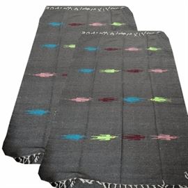 Pair of Molina Handwoven Mexican Blankets: A pair of matching Molina handwoven Mexican blankets. The matching blankets feature horizontal rows of stylized turquoise blue, light green, maroon and pink birds on a dark gray background. The ends of the blankets have white fringe. A tag attached to one is marked “Molina Indian Blanket – 50% Acrylic – 40% Polyester – 10% Cotton – Hand Woven Made in Mexico”.