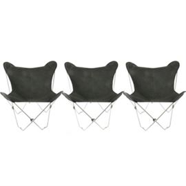 Set of Safari-Style Folding Chairs: A set of three matching safari-style folding chairs. The chairs have silver tone metal hinged frames, and 100% cotton canvas sling fabric seats. The black fabric seats attach to the frames via sewn-in pockets on the four corners. No manufacturer’s marks. The seats are labeled “Made in China – 100% Cotton”.