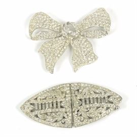 Vintage Rhinestone Brooch and Clip: A vintage silver tone metal and rhinestone brooch and sweater or fur clip. The marquise-shaped clip features pave clear rhinestones to the surfaces. Also included is a bow-shaped silver tone metal brooch with pave clear rhinestones. Neither are marked.