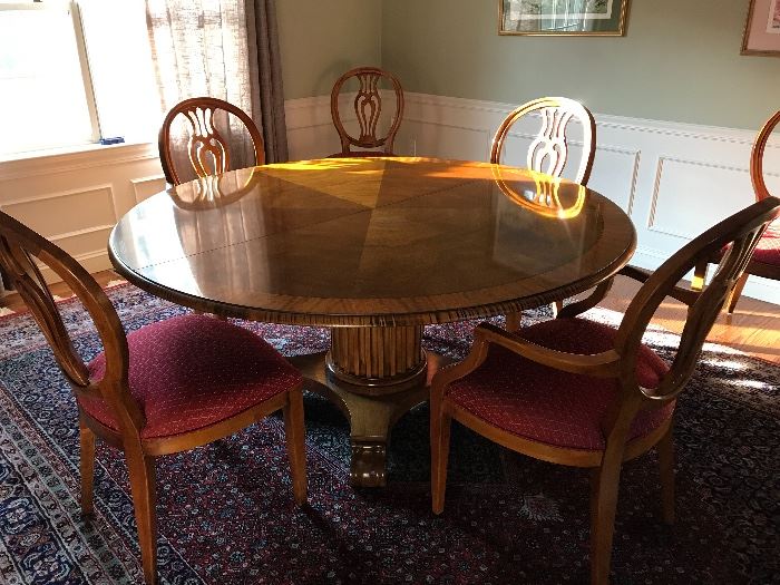 Henredon Round Dining Table with one leaf, pads, two Natchez Collection arm chairs and 6 Natchez Collection dining chairs. 
American made -- the fluted column pedestal and scrolled feet have classical motifs. 
Measurements are 5' 4" diameter and 30" tall.

