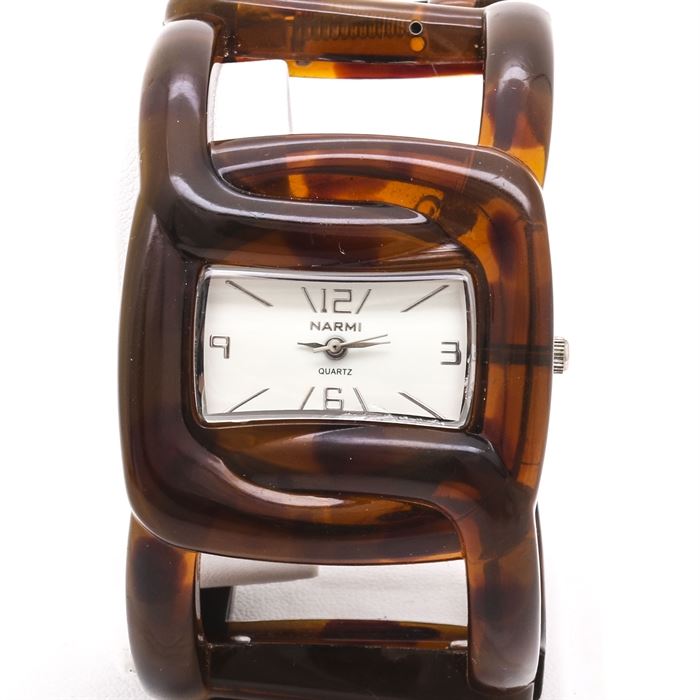 Narmie Quartz Hinged Cuff Watch: A Narmie quartz hinged cuff fashion watch. This watch features a white dial, gold tone Arabic and index hour markers, and finishes with a plastic spring hinged bracelet.