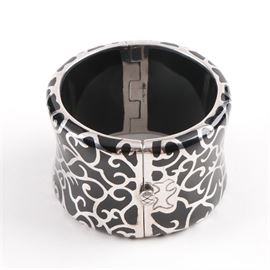 Angelique de Paris Sterling Silver Bracelet: A hinged sterling silver cuff bracelet with a scrolling foliate motif by Angelique de Paris.