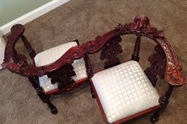 This Conversation, Tete A Tete or Courting Seat is a reproduction heavily carved Victorian Dark Mahogany upholstered Face Chair. Very Nice.