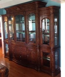 Gorgeous three sectional dining room Hutch with glass shelves and lights with touch on feature includes a timer for lights to come on and off throughout the day. Put all three pieces together for a dramatic look, or separate the sides for each piece to stand along as curio Cabinets. Very nice and versatile piece.