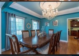 Dining Room Table with two center leaves and twelve matching chairs. Like New! Extra 4 chairs not in this picture are located around kitchen table.