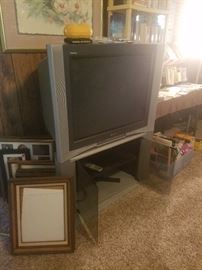 Large television with stand, picture frames, & more. 