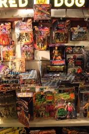 Lots of toys and action figures, including Simpsons, Futurama, The Tick, Pee Wee Herman, Aliens, Predator, Spawn, Terminator, Toy Story, etc.