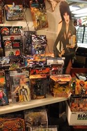 Lots of toys and action figures, including Simpsons, Futurama, The Tick, Pee Wee Herman, Aliens, Predator, Spawn, Terminator, Toy Story, etc.