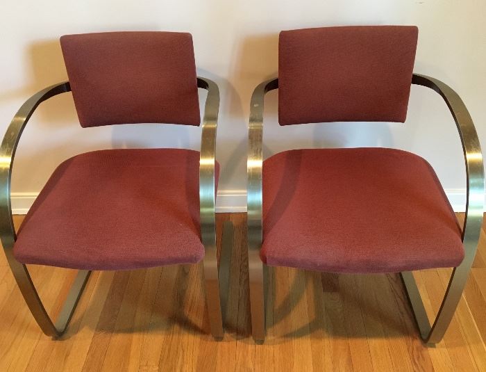 Pair Breuton stainless with brass finish, cantilevered arm chairs
