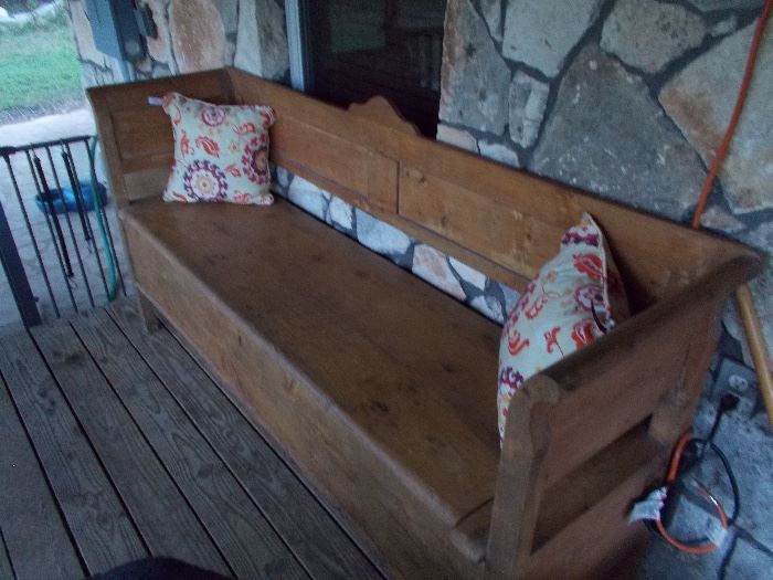 Wooden bench with large storage area under seat.