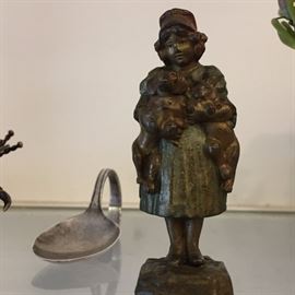 silver spoon, brass figurine