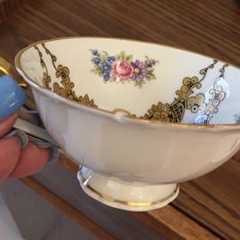 Several saucer and tea cups with dessert plate.  From England or Germany