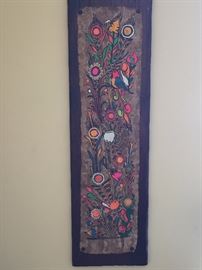 Mexican wall hangings with vibrant colors painted on bark
