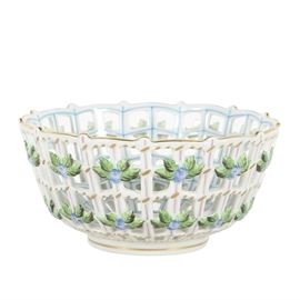 Herend Porcelain Lattice Bowl: A porcelain lattice fruit bowl from Herend, Hungary. The bowl has a hand painted floral spray in the center, applied green and indigo blue flowers along the lattice body and the rim is trimmed in gold. Blue back stamp appears underneath.