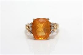 18K Yellow Gold 3.80 CTS Fire Opal and Zircon Ring: A large faceted rectangular fire opal is basket prong set to the center of a yellow gold shank with openwork design to the bridge and round cut zircon accents to the shoulders.