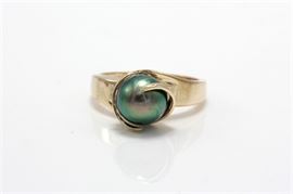 14K Yellow Gold Cultured Pearl Ring: A yellow gold shank that curls around a semi-round dyed black pearl to the center.