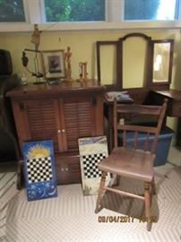 One of several plank seat chairs, vanity behind the chair, two game boards are hand painted. Maple cabinet is also pictured. 