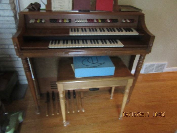 electric organ with bench that stores music. 