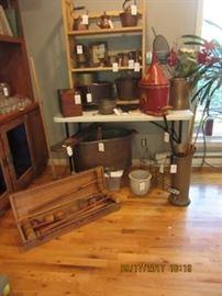 Early croquet set in front with copper teapots, coffee pot, and bucket. The large piece on the floor is a copper sink. The red piece is from a rice co. in Orange NJ.  A Pennsylvania fracktur is on the middle shelf.     