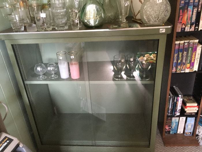 Wow! A retro metal display cabinet with sliding glass doors -- nice vintage drinking glasses/decanters and more.