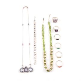 Sterling Silver Jewelry Including Pieces with Peridot: An assortment of sterling silver jewelry. Featuring nine pieces, this selection includes two necklaces, a bracelet and six rings. Some pieces include peridot, iolite, amethyst, rhodolite garnet and labradorite moonstone. Each piece is hallmarked or tested as sterling silver and the total weight, inclusive of all materials, is 2.285 ozt.