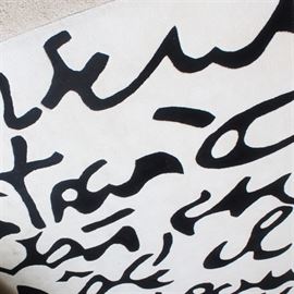 Machine-Made Contemporary Area Rug: A machine-made contemporary area rug. This features highly stylized black lettering in an unknown language, over a white field. Edges are finished on all sides. The rug is unmarked.