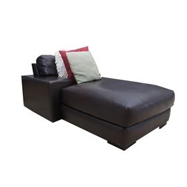 An overstuffed chaise lounge by American Leather. This lounge features a cushion back over a large chaise cushion flanked on one side by a large rectangular arm. The lounge rises above large block feet. The piece is marked “American Leather.” This lounge matches items: 17IND136-061 and 17IND136-059.