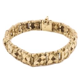 14K Yellow Gold Fancy Link Bracelet: A high polish 14K yellow gold fancy link bracelet. This bracelet features rough textured links with a high polish affixed to a hidden box tab with a safety catch.