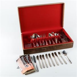 Collection of Community Plate "Grosvenor" and "Deauville" Plated Silver Flatware: A collection of plated silver flatware by Community Plate. Collection includes two different patterns, Grosvenor and Deauville. Present are eight dinner knives, eight butter knives, eight luncheon knives, eight salad forks, eight table spoons, fifteen teaspoons, one serving spoon, one dessert spoon, one jelly spoon, six dinner knives, six dinner forks, six salad forks, twelve teaspoons, five serving spoons, two butter knives, a ladle, a table spoon, a pickle fork, and a single spoon by Holmes & Edwards.