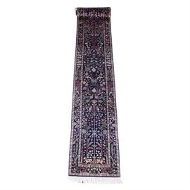 Hand-Knotted Persian-Style Wool Carpet Runner: A hand-knotted Persian-style carpet runner. This wool rug, attributed to Turkish weavers, is rendered in a palette of deep midnight blue, celadon, lavender, and tan. It features a crisp tree of life pictorial design over a midnight blue field. Populating the field are numerous songbirds, fallow deer, rams, and other animals amid flowering branches, palmettes, and lancet leaves. The field is framed by three borders, including a primary border filled with flowers, leaves, and vines over midnight blue, and two meandering floral minor borders over celadon. Selvedges are double overcast. Top and bottom finish with long, knotted wool warp fringe. The rug is unlabeled.