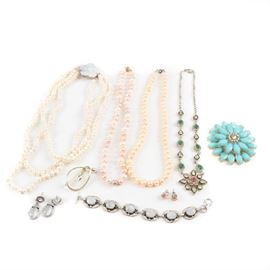 Assorted Costume Jewelry Including a Moonstone Bracelet: An assortment of costume jewelry. Featuring nine pieces, this selection includes necklaces, a bracelet, brooches and earrings. Highlighted materials include cultured pearl, moonstone, resin and foil backs. Featured items include a bracelet and pair of earrings with moonstones, a large brooch with resin and foil back accents and a cultured pearl necklace.