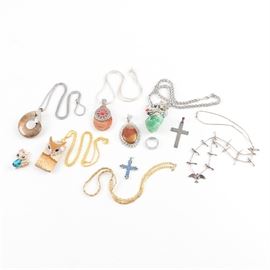 Assortment of Costume Jewelry: An assortment of costume jewelry. This collection includes six necklaces, four pendants, and one ring. They are adorned with agate, picture agate, fluorite, and coiled ammonoid stones.