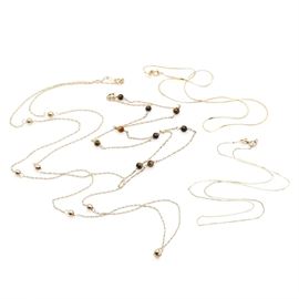 Assortment of 14K Yellow Gold Chain Necklaces Including Tiger's Eye: An assortment of 14K yellow gold chain necklaces including tiger’s eye. This assortment features two 14K yellow gold serpentine link chain necklaces, a 14K yellow gold twist link chain necklace with gold beaded accents and a 14K yellow gold twist link chain necklace featuring tiger’s eye beaded accents.