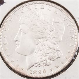 1896 Morgan Silver Dollar: An 1896 Morgan silver dollar. Designer: George T. Morgan. Mintage: 9,976,000. Metal Content: 90% silver, 10% copper. Diameter: 38.1 mm. Weight: approx. 26.73 grams. Very good condition.