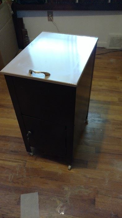 Filing cabniet. Too lifts up bottom drawer opens and locks with key.