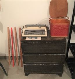 old chest,  vintage electric typewriter and picnic basket