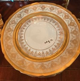 beautiful set of gold and white dinner plates