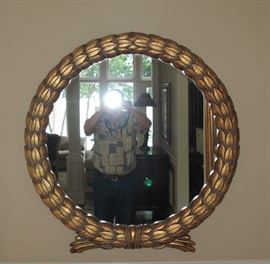 One of a pair of matching gold mirrors