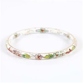 Cloisonné Bangle Bracelet: A cloisonné bangle bracelet. The bracelet is made of brass and is decorated with enamel with a floral motif. The piece is unmarked to indicate a maker.