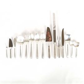 Towle "Craftsman" Sterling Silver Serving Pieces: A collection of sterling silver serving pieces by Towle Silversmiths. In the Harold E. Nock designed Craftsman pattern, these feature slightly flaring handles with faceted ends. The set includes a ham slicer, carving knife, carving fork, cake server, pie server, master butter knife, sugar spoon, lemon fork, bon bon spoon, tomato server, pierced casserole, large berry/casserole spoon, serving spoons, and a cold meat fork. The total approximate weight, excluding hollow pieces and those with stainless steel blades, is 17.020 ozt.